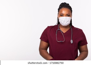 African american doctor in a medical mask over white background with copy space. Medicine, healthcare and people concept. - Powered by Shutterstock