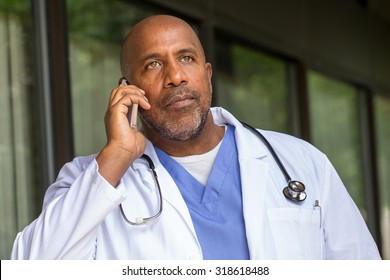 African American Doctor Texting On The Phone.