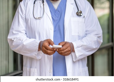 African American Doctor Texting On The Phone.