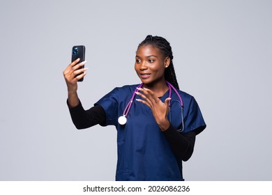 African American Doctor Woman Gown Doing Selfie Shot On Mobile Phone Make Video Call. Healthcare Personnel Medicine Concept.