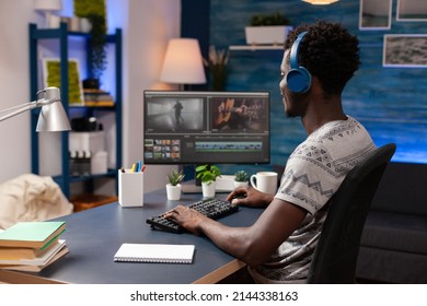 African american editor retouching video montage editing visual effects for movie project on computer. Videographer man working remote from home at footage using digital post production software