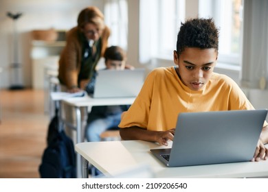 African American Elementary Student E-learning On Laptop In The Classroom.