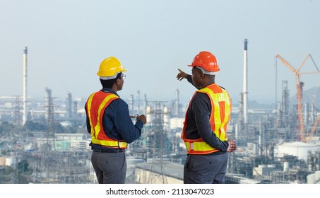 African American Engineer Is Discussing On Furture Plan While Looking Over The Petroleum And Crude Oil Refinery Factory For Power Industry