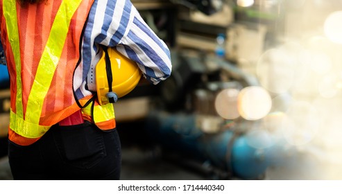 African American engineer Woman wearing safety goggles control lathe machine to drill components. Metal lathe industrial manufacturing factory. Engineer Operating  lathe Machinery - Powered by Shutterstock