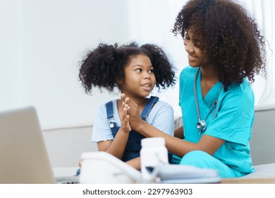 African American ethnicity female doctor and little girl in hospital, pediatrician taking to a little girl who laying down on the bed or sofa in hospital to talk about her sickness. - Powered by Shutterstock