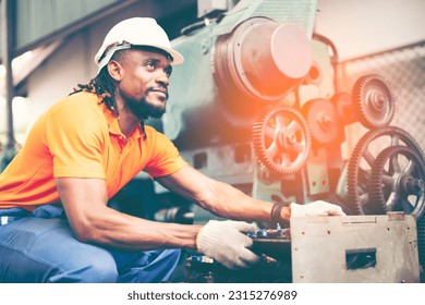 African american factory male worker. Engineer man worker in plant production drilling at machine in smart factory wearing yellow hard hat safety first at mechanic factory. - Shutterstock ID 2315276989
