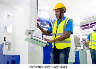 African American Factory Worker Work With The Machine In Workplace Area. Concept Of Good Management System To Support Industrial Business Working.