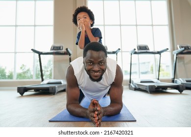 African American Family Dad And Kid Workout In Prank Pose In Sport Club For Health And Wellbeing Concept