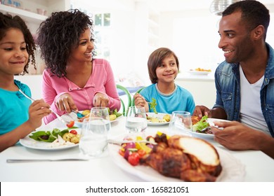 African American Family Eating Meal At Home Together