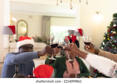 African American Family Having Christmas Meal And Drinking Wine. Christmas, Family Time And Celebration Concept.