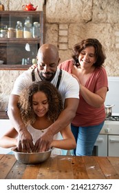 African American family having fun in their home kitchen while cooking a cake together - Shutterstock ID 2142127367