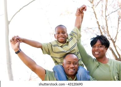 African American Family Having Fun In The Park.