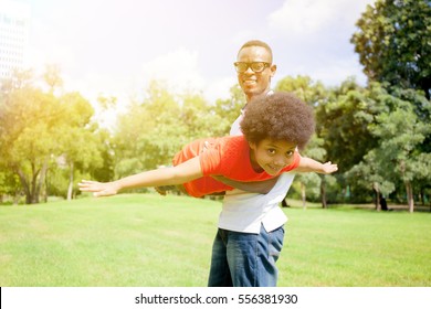 African American Family Having Fun In The Outdoor Park During Summer