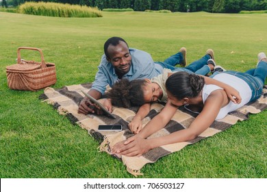 African American Family Having Picnic Together In Park