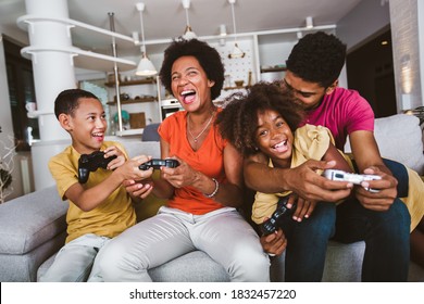 African American Family At Home Sitting In Sofa Couch And Playing Video Games Together