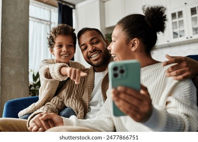 African American family joyfully taking selfie together with cell phone. - Powered by Shutterstock