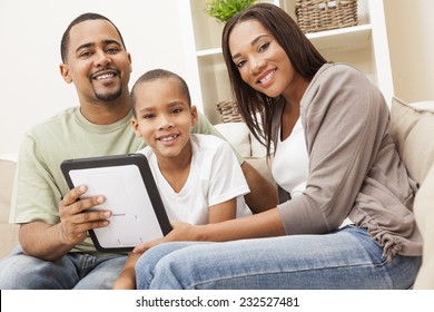 African American Family, Parents And Son, Having Fun Using Tablet Computer Together