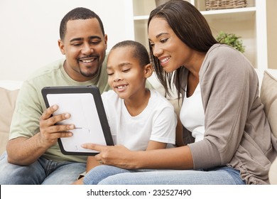 African American Family, Parents And Son, Having Fun Using Tablet Computer Together