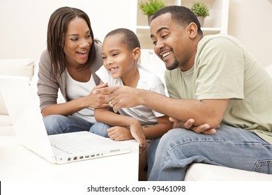 African American family, parents and son, having fun using a laptop computer together