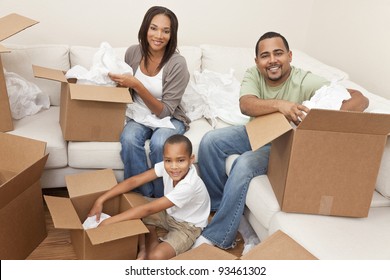African American family, parents and son, unpacking boxes and moving into a new home, The adults are unpacking crockery and houseware.