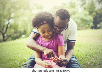 African American family playing together in the outdoor park
