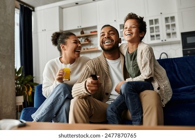 African american family share laughter on couch. - Powered by Shutterstock