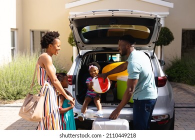 African American Family Smiling While Standing Near Their Car Outdoors. Family Trip And Vacation Concept, Unaltered.