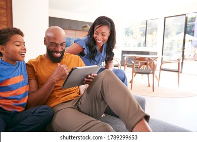 African American Family With Son Sitting On Sofa At Home Using Digital Tablet - Shutterstock ID 1789299653