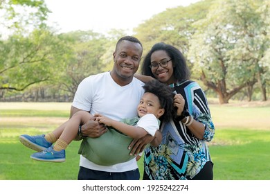 An African American family spent time together in the park, African American parents (Father, Mother) and little boy enjoying during relax togetherness. African American family life concept.