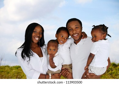 African American Family Together Outside In A Field