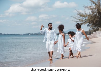African American family walking together on the beach. Having fun on a tropical beach.