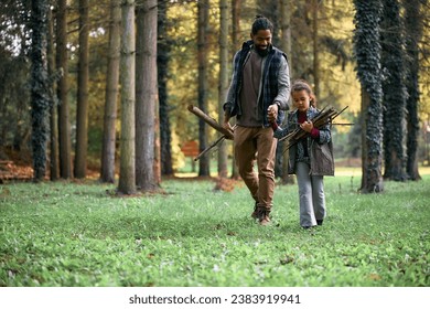 African American father and daughter collecting twigs while camping in nature. Copy space. - Powered by Shutterstock