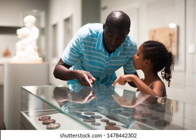 African American Father And Daughter Looking At Stands With Exhibits At Historical Museum 