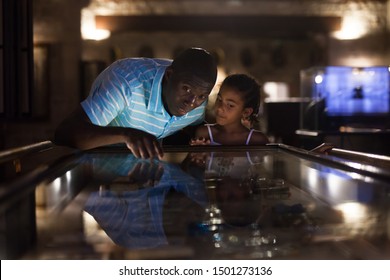 African American Father And Daughter Looking At Stands With Exhibits At Historical Museum 