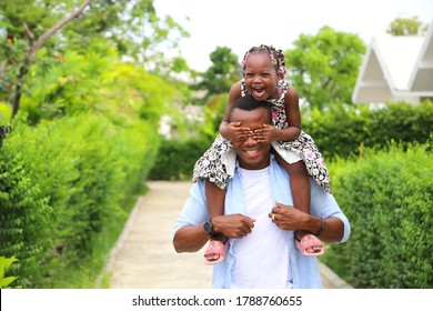 African American Father Gave Piggyback Ride To His Little Daughter With Happy Mental Health And Having A Good Time Together While Walking Outside The House Around The Neighborhood