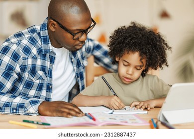 African american father helps son to do homework at home
 - Powered by Shutterstock