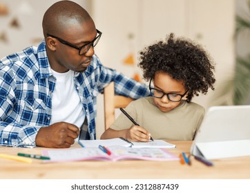 African american father helps son to do homework at home
 - Powered by Shutterstock