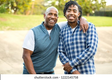 African American Father And His Adult Son Talking And Laughing.