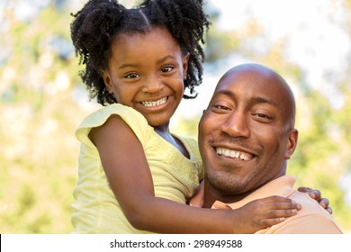 African American Father Holding His Daughter