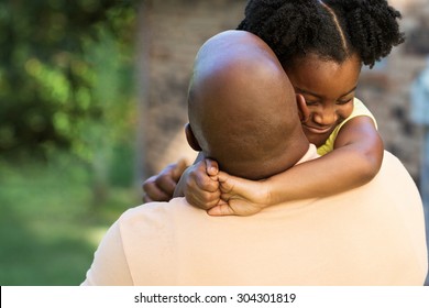 African American Father Hugging His Daughter