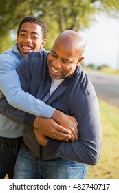 African American Father Playing 
Football With His Son.