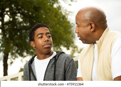 African American Father And Son In Deep Conversation.