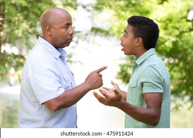 African American Father And Son In Deep Conversation.