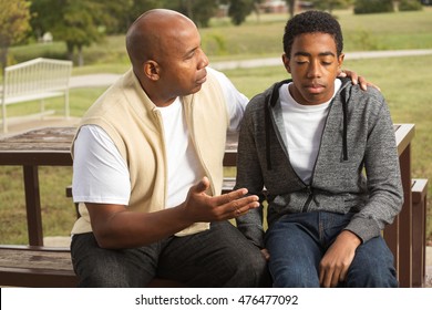 African American Father And Son In Deep Conversation.