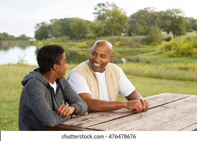 African American Father And Son In Deep Conversation.