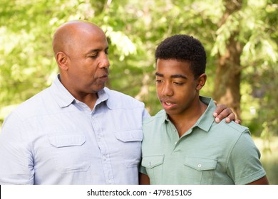 African American Father And Son In Deep Conversation.