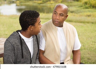 African American Father And Son In Deep Conversation.