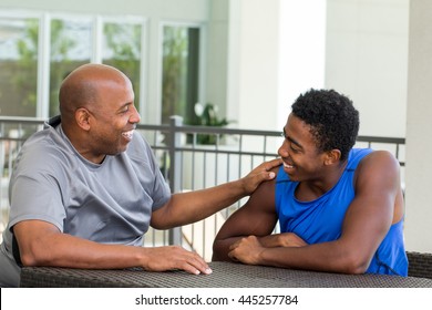 African American father and son talking