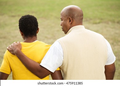 African American Father Talking To His Son.