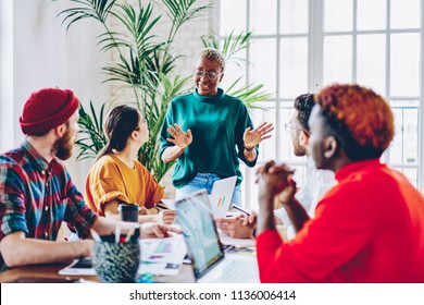 African american female coach speaking during workshop with crew of students explaining strategy in business school, creative dark skinned woman share her opinion with colleagues during work - Shutterstock ID 1136006414